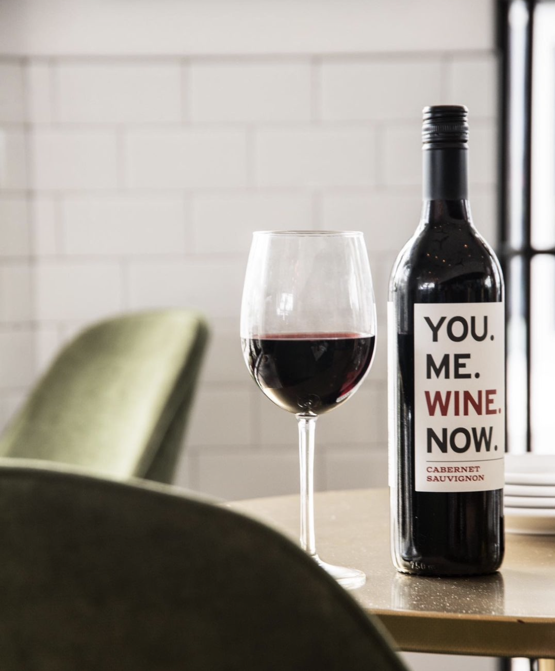 a close up of a bottle and a glass of wine