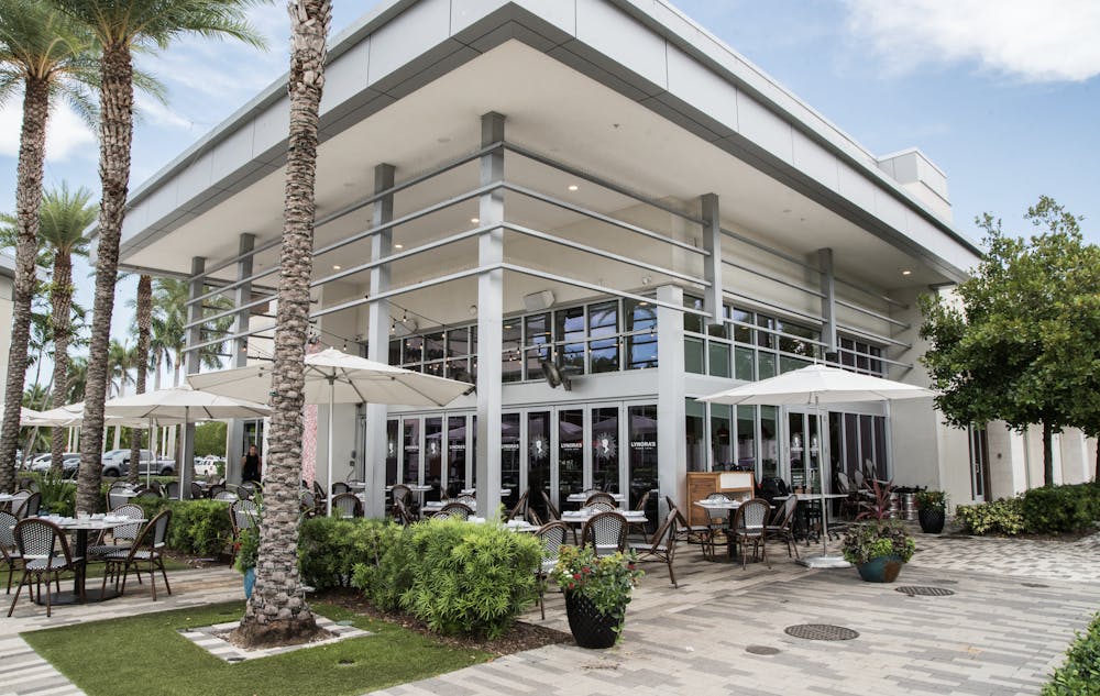 a group of people sitting at a table in a restaurant