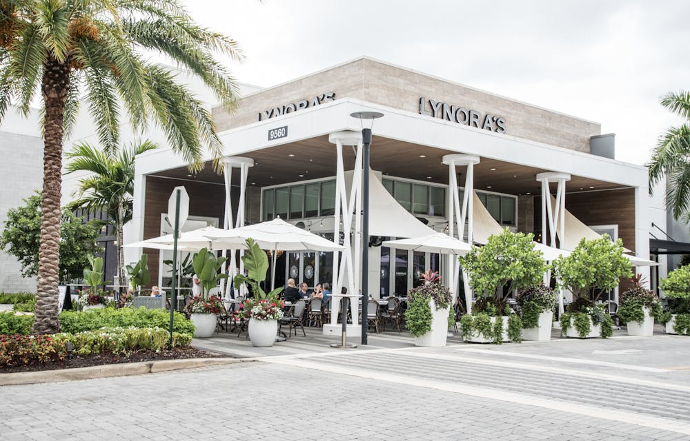 a palm tree in front of a building
