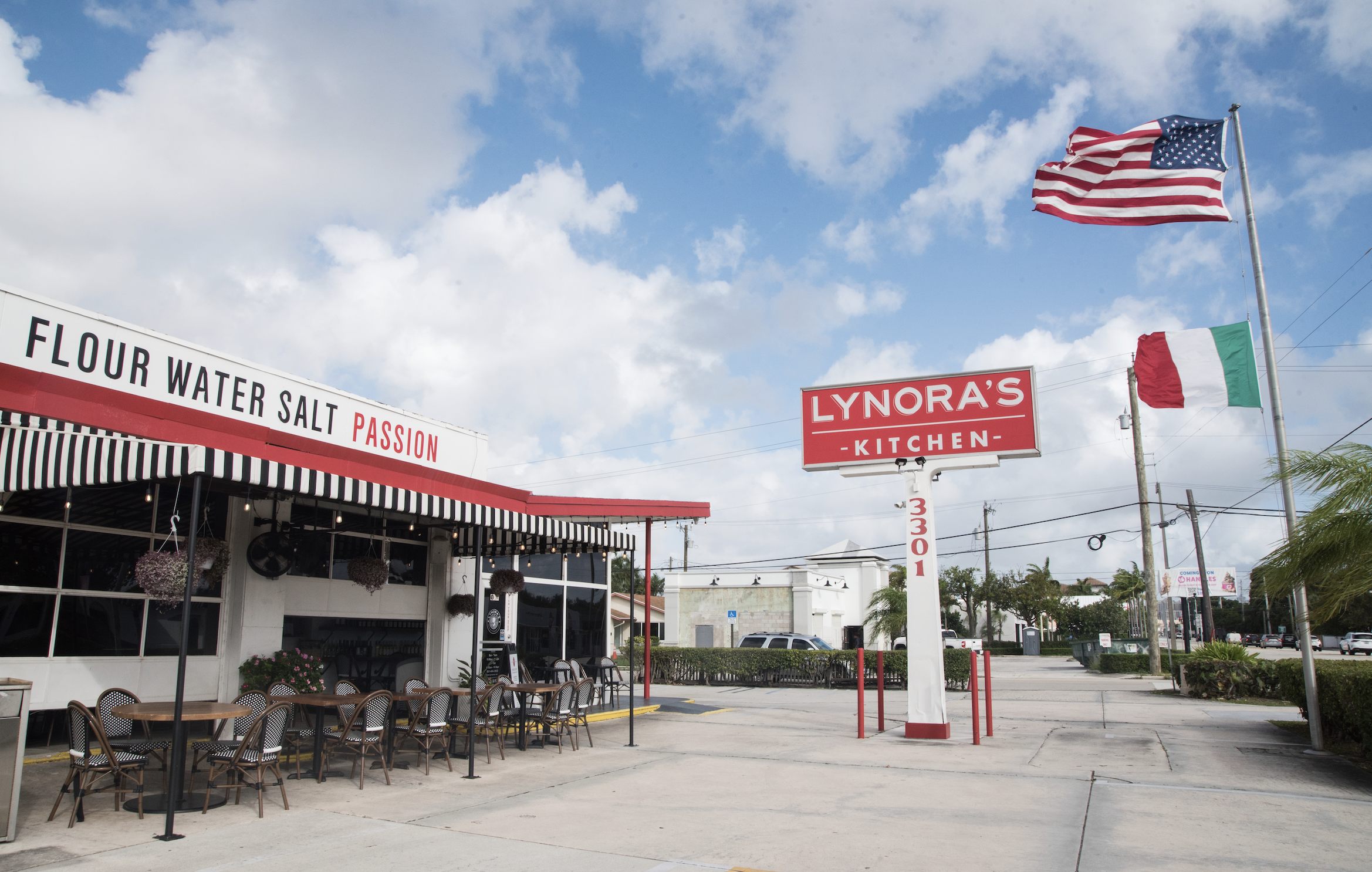 a group of people walking in front of a store