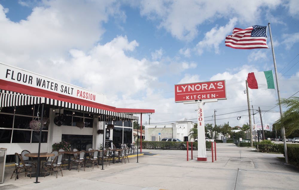 a group of people walking in front of a store