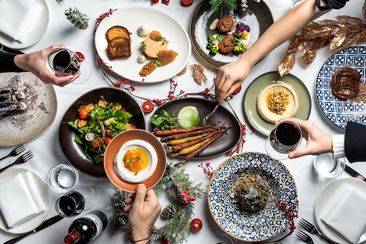 a group of people sitting at a table with a plate of food