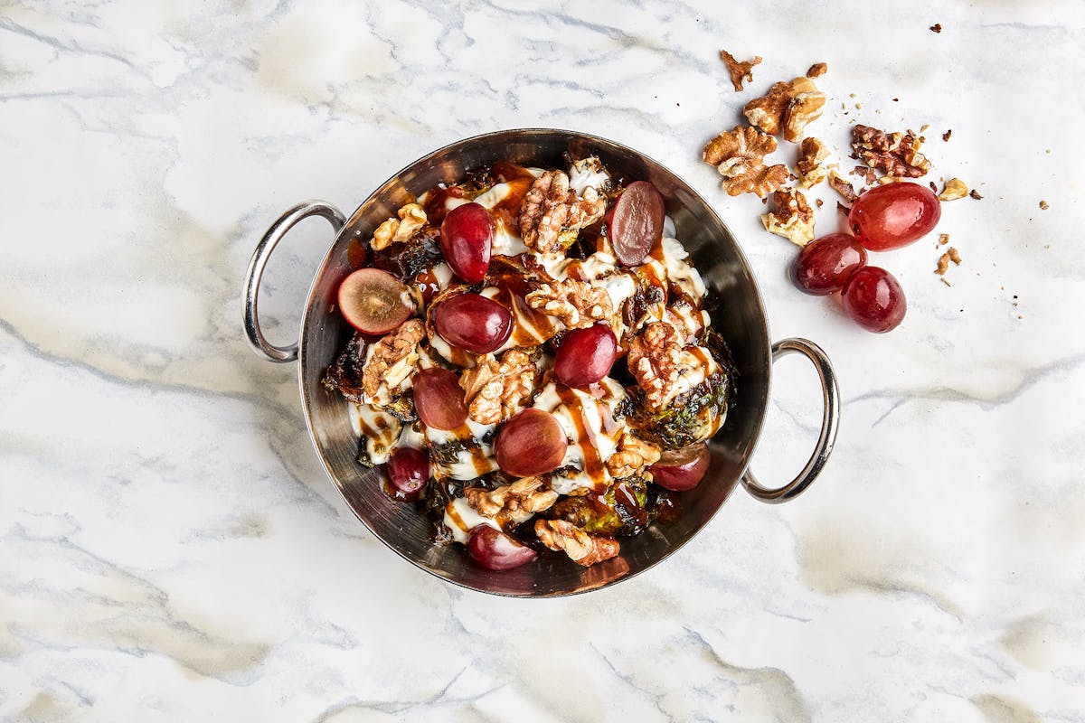 a bowl of fruit sitting on top of snow covered ground