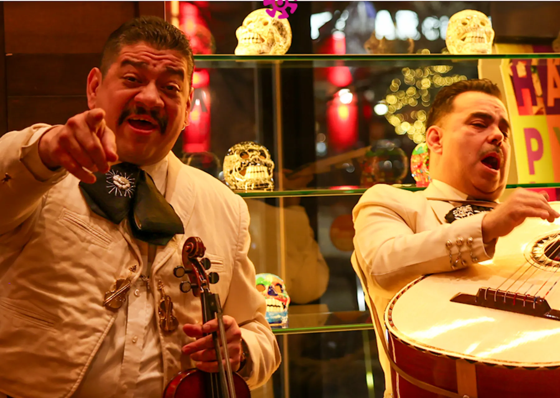a man holding a violin and a man pointing