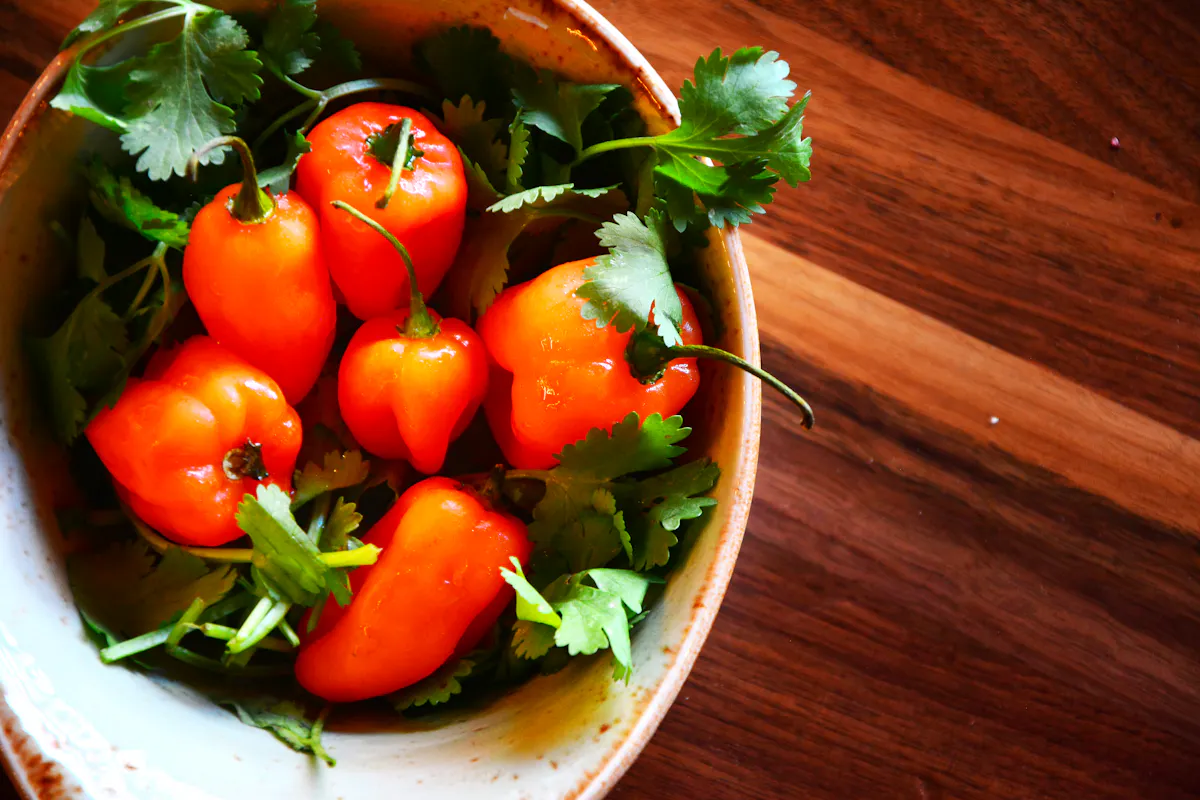a bowl of fresh vegetables on a wooden table