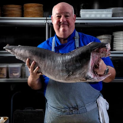 a man holding a fish