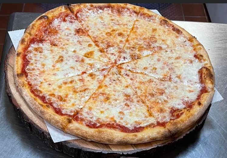 a pizza sitting on top of a metal pan