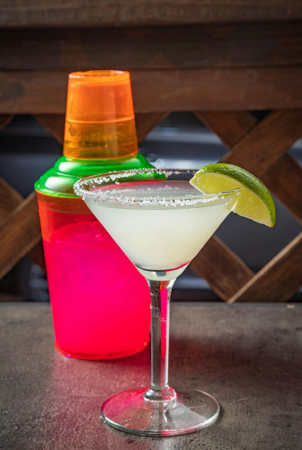 a martini glass filled with margarita pictured next to a shaker on the patio at Arnaldo Richards' Picos Restaurant in Houston, TX
