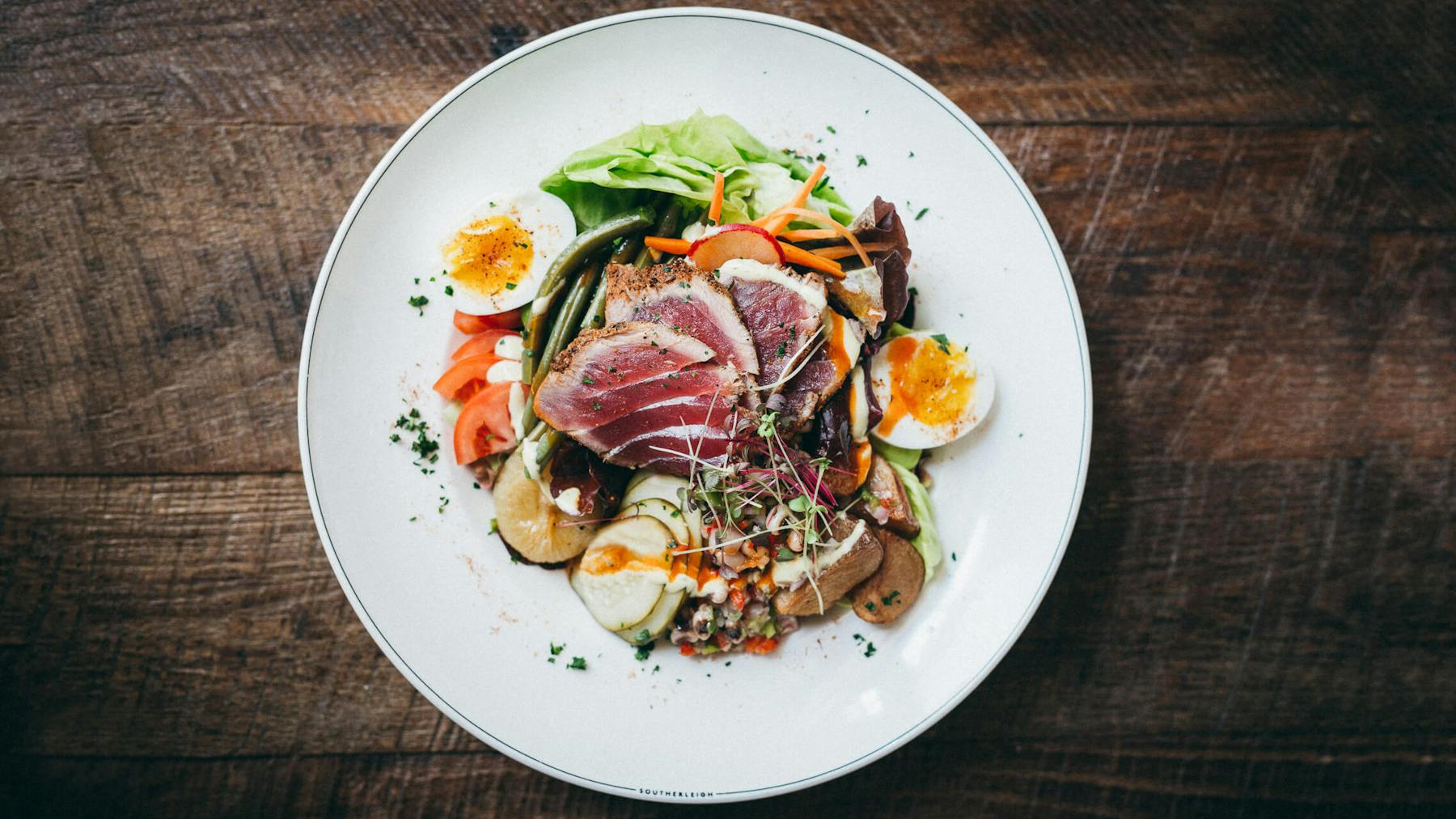 a white plate topped with different types of food on a table