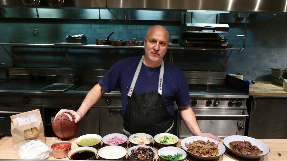 Tom Colicchio preparing food in a kitchen