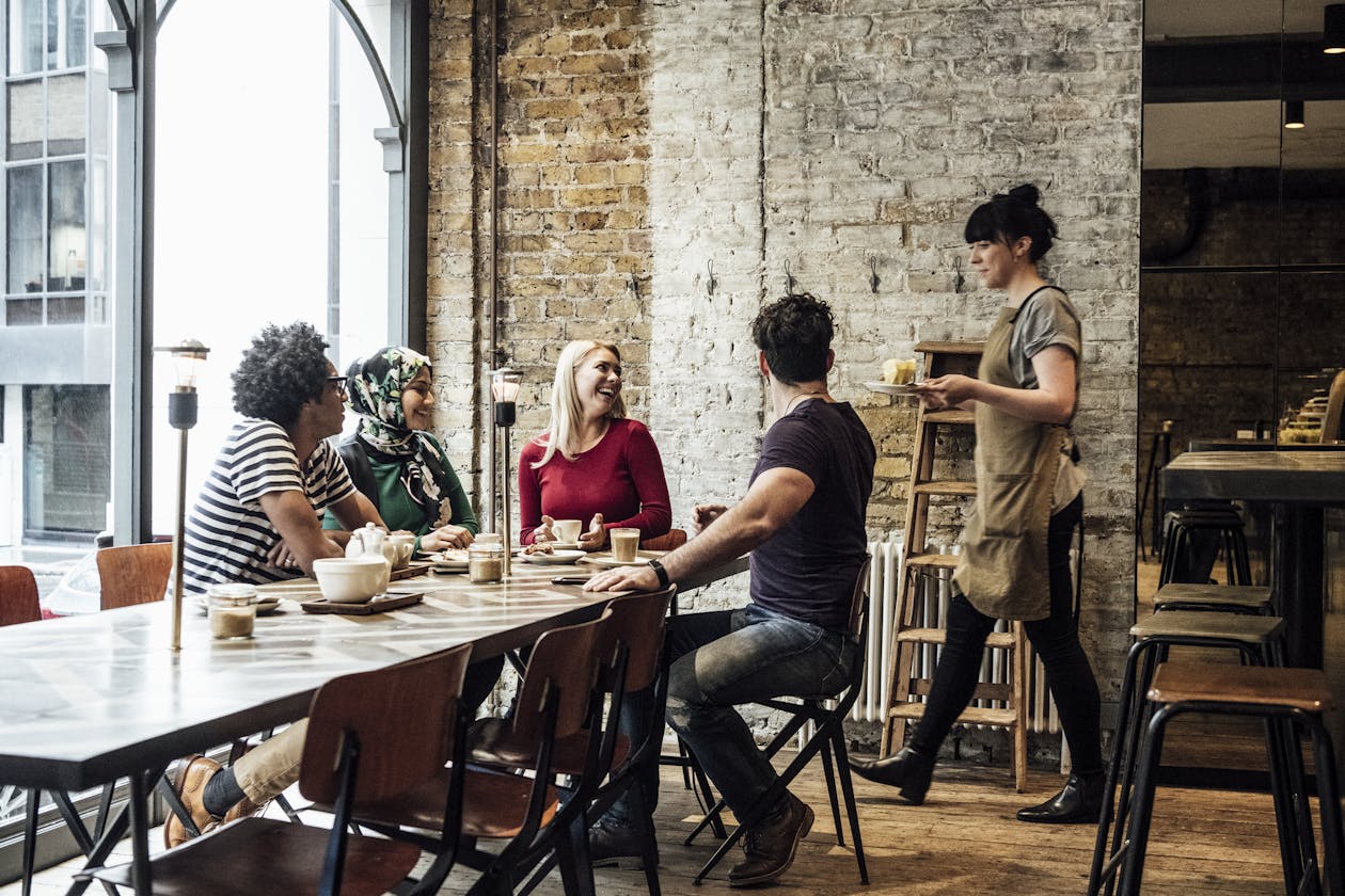 a group of people sitting at a table in a restaurant