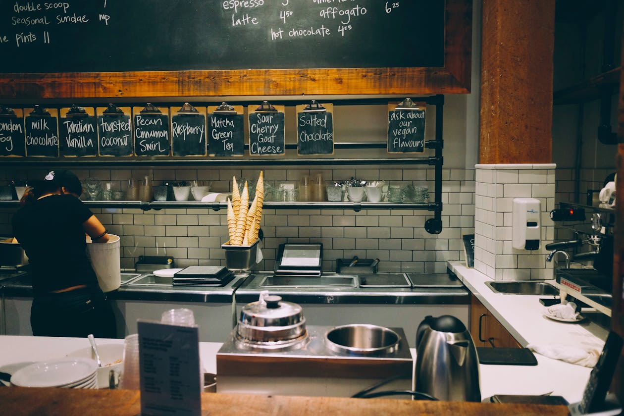 a person sitting at a table in a restaurant kitchen