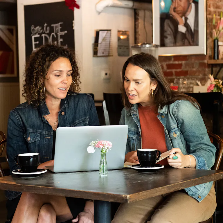 Two people working at a table 