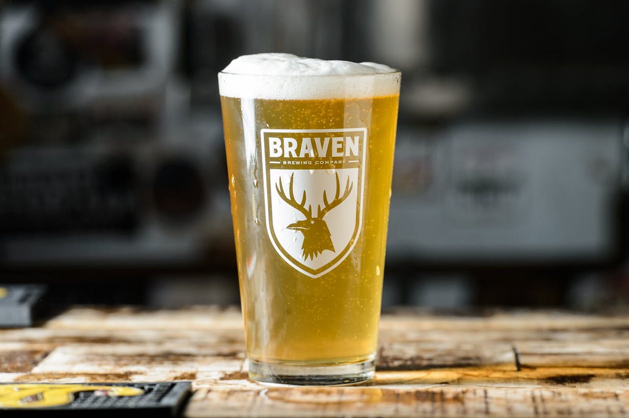 A glass of beer on a table.