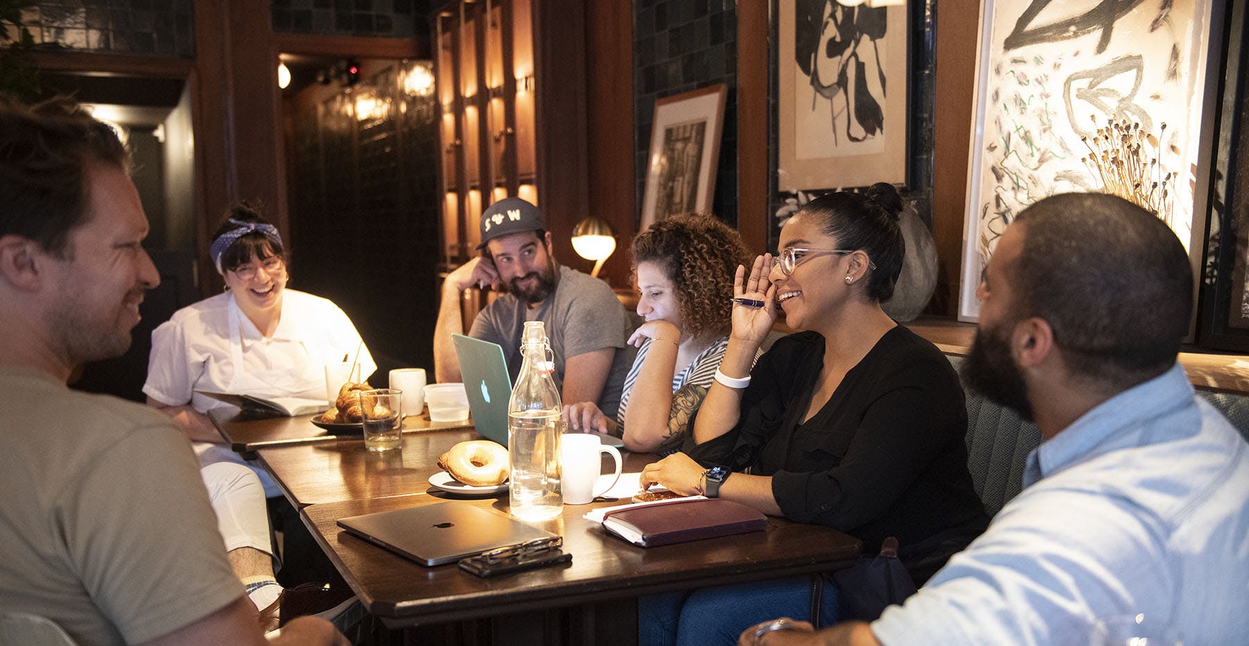 a group of people sitting at a table in a restaurant