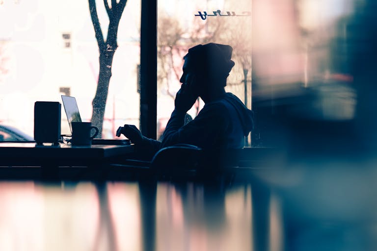 A person sitting at a cafe on their laptop looking at a restaurant website.