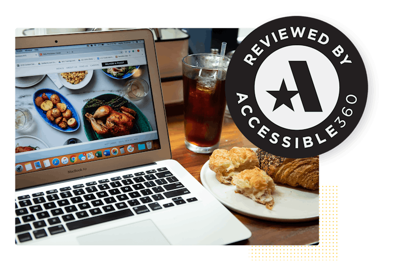 a certified accessible website on a table with a plate of pastries