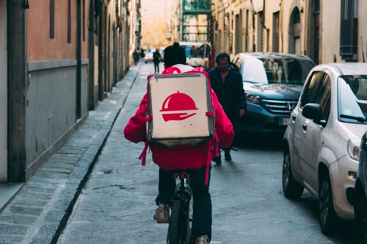 a delivery person on a bike.