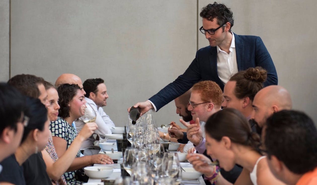 a group of people sitting at a table with wine glasses