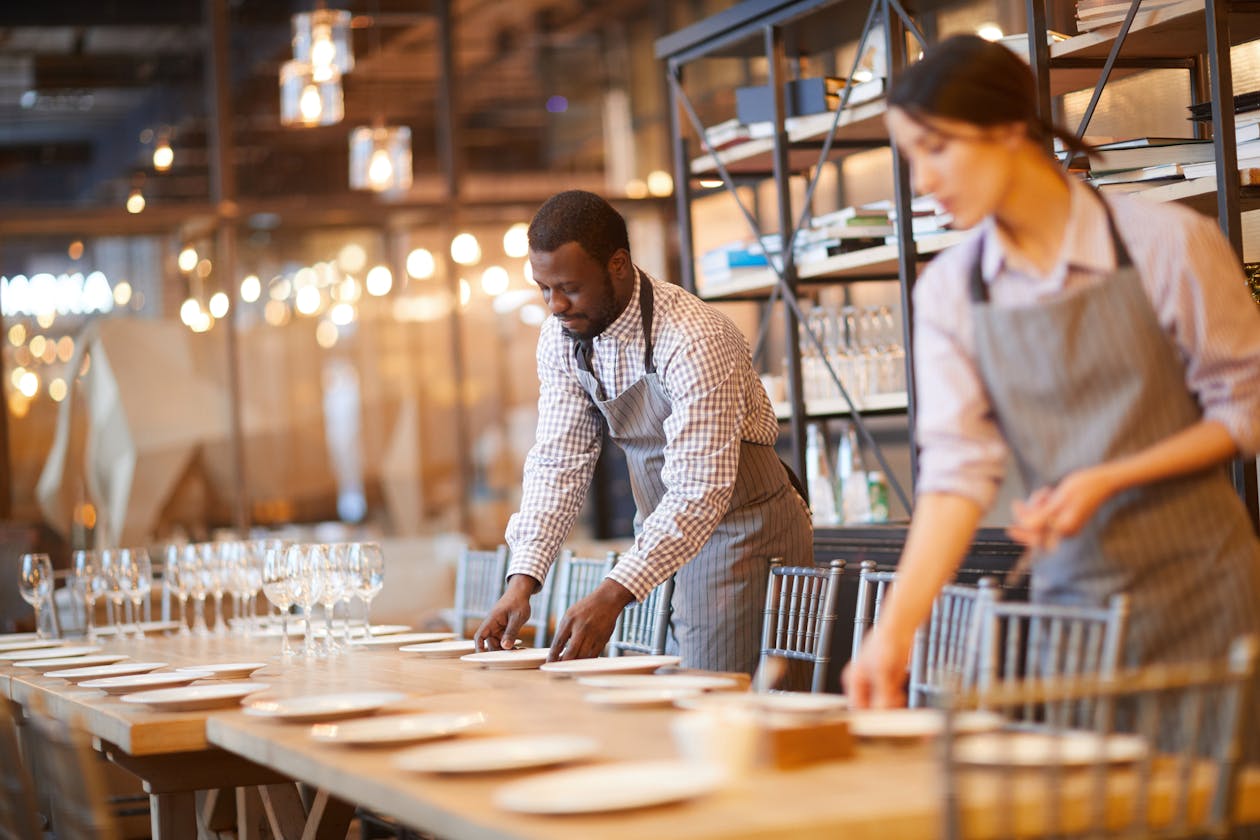 a group of people standing around a table