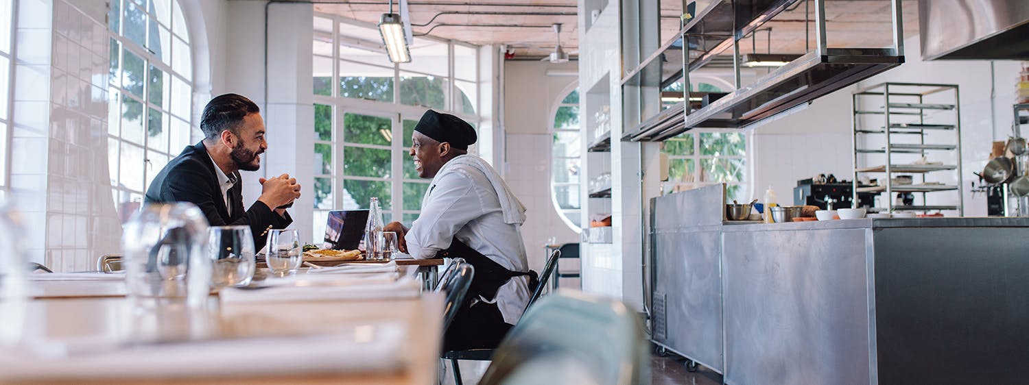 a man sitting at a table in a restaurant