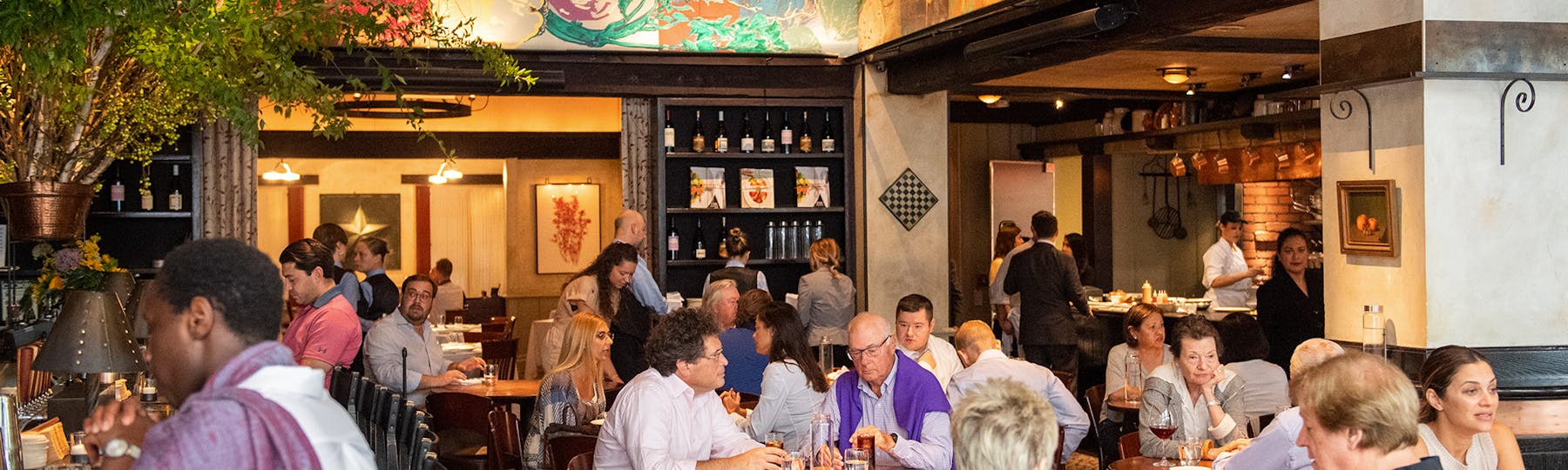 a group of people sitting at a table in a restaurant