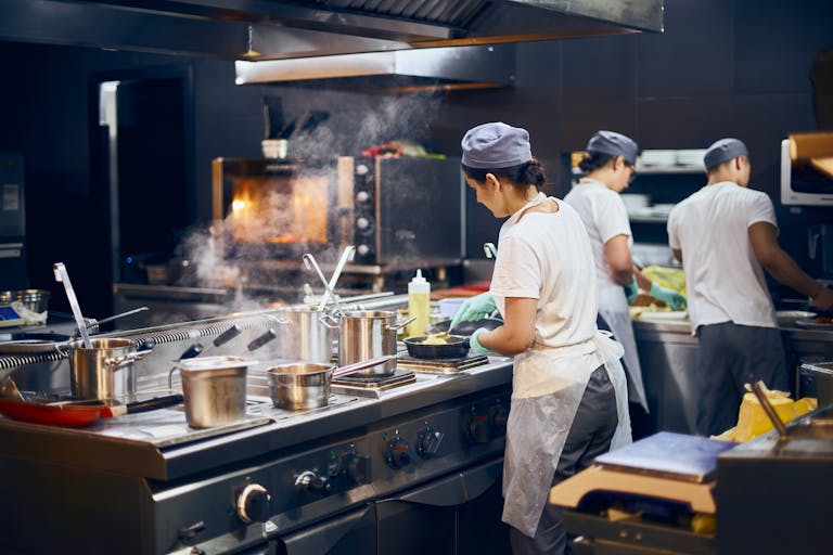 a man cooking in a kitchen preparing food