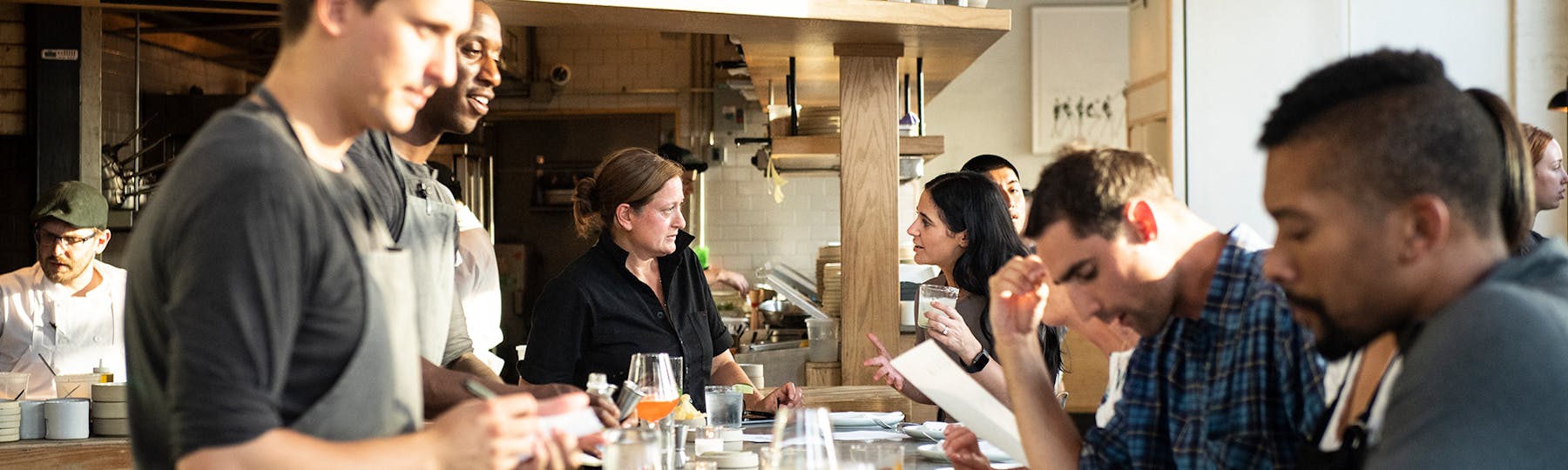 a group of people preparing food in a kitchen