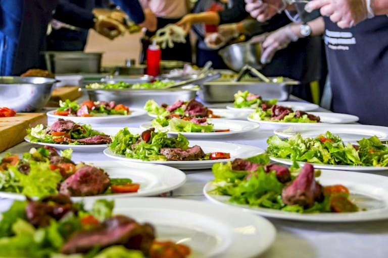 chefs preparing plates of food