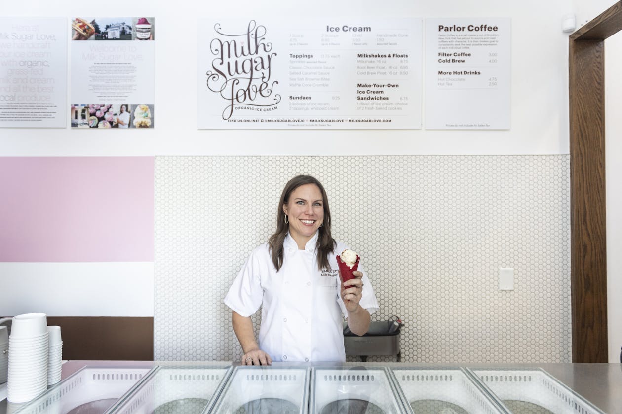 a woman standing with an ice cream cone.