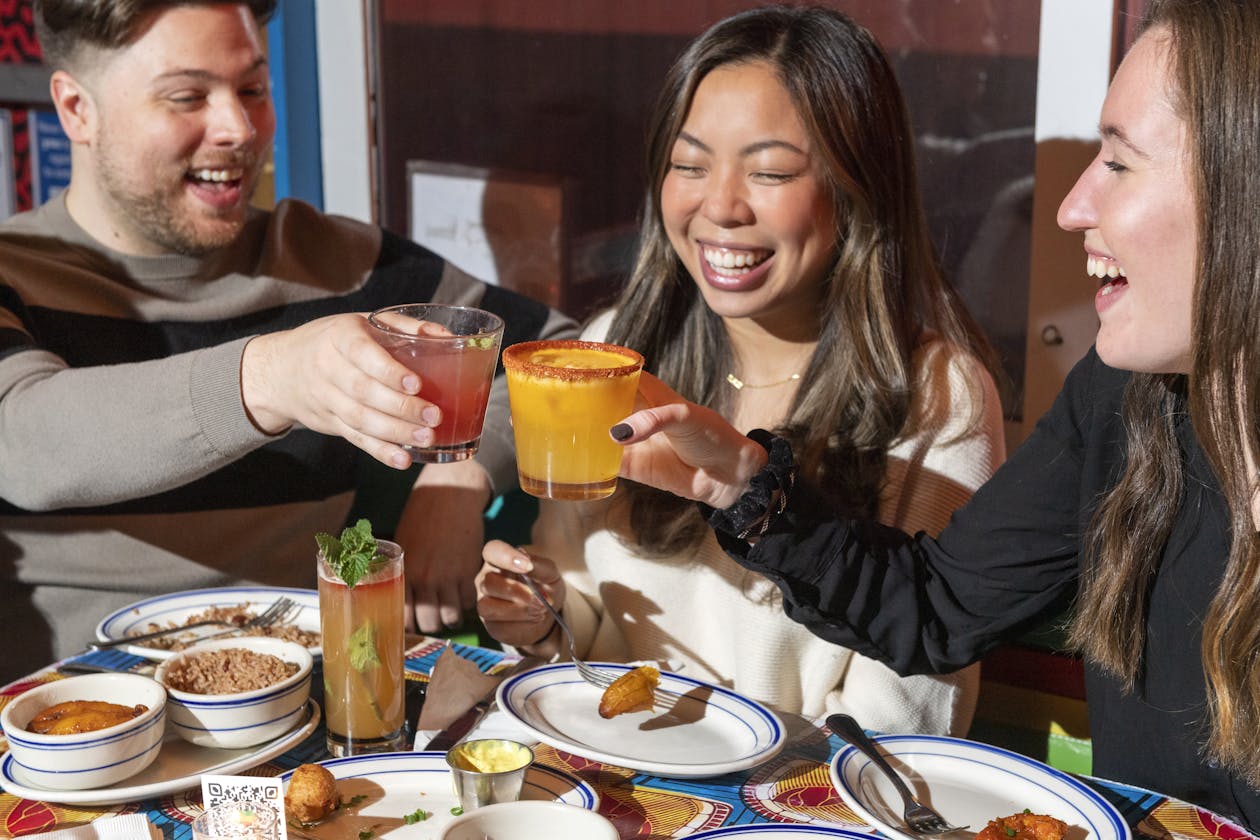 a man and a woman sitting at a table with a plate of food