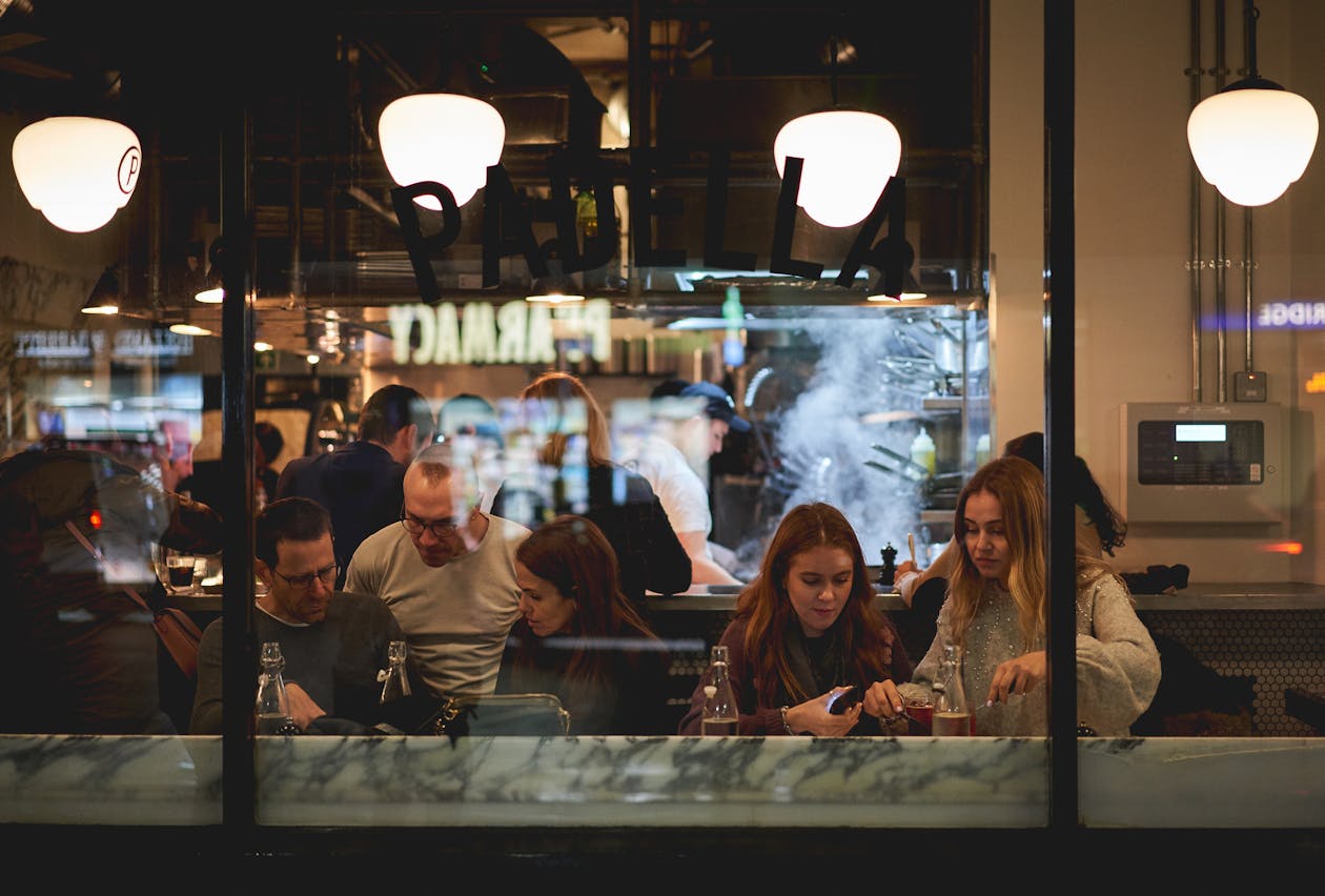 a group of people sitting at a table in a restaurant