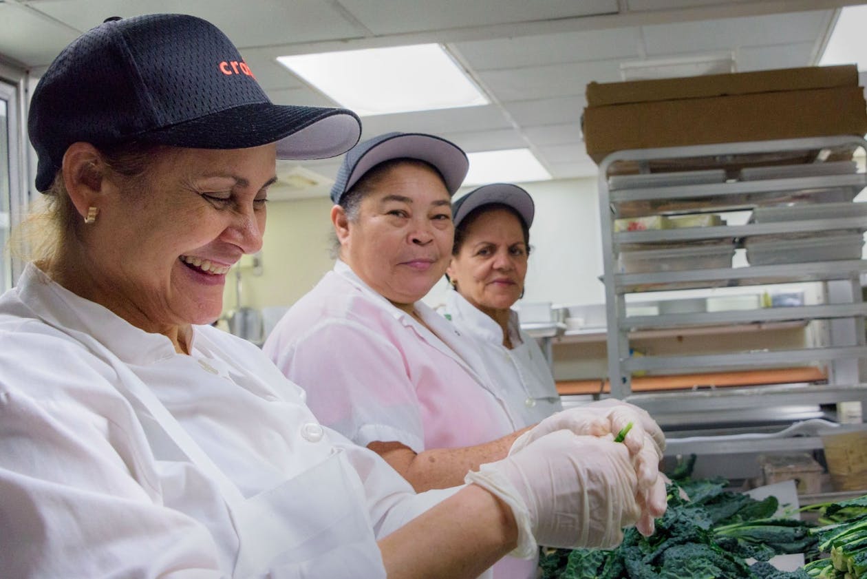 A group of people working in a kitchen.