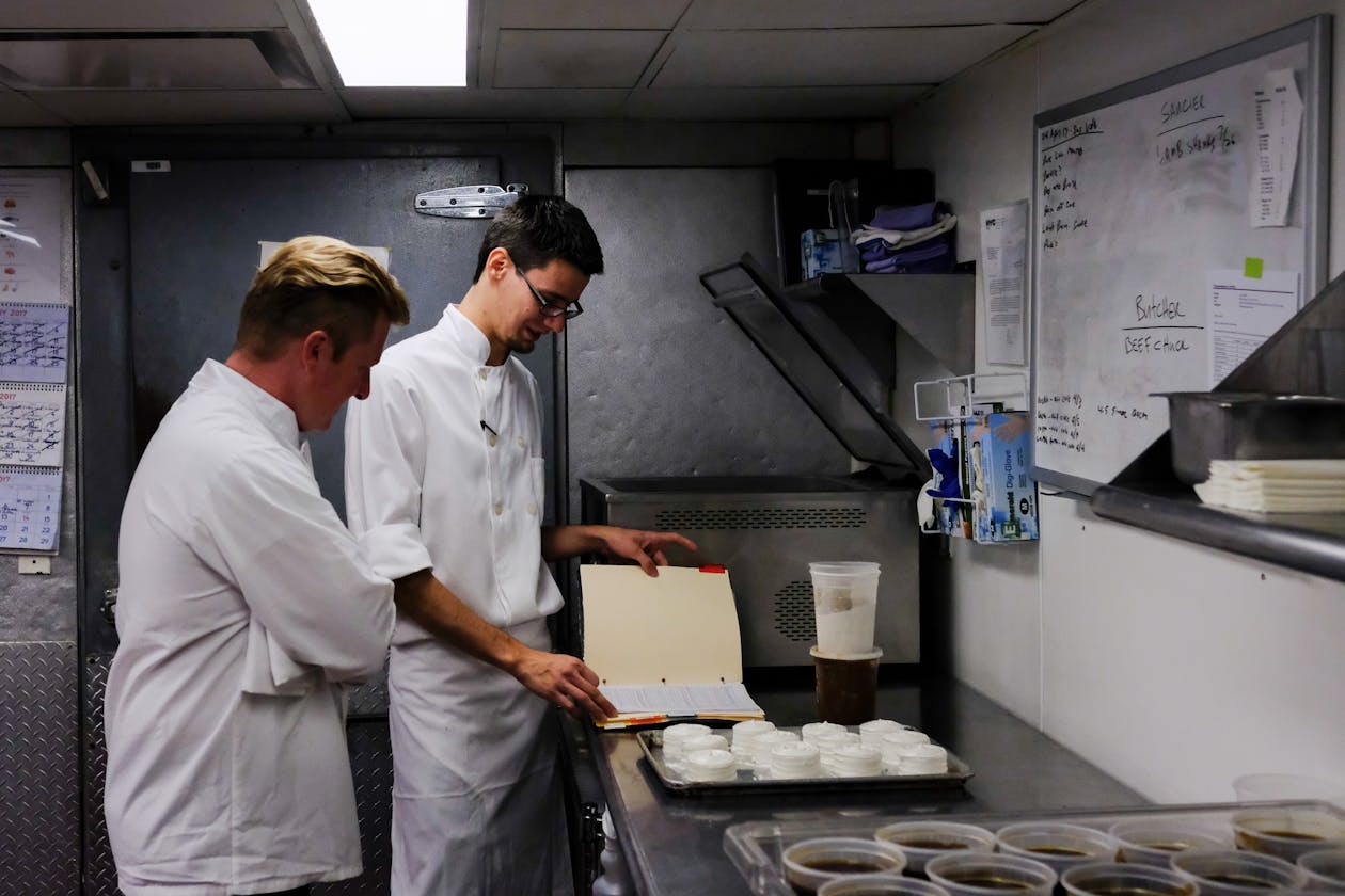 a man standing in a kitchen preparing food