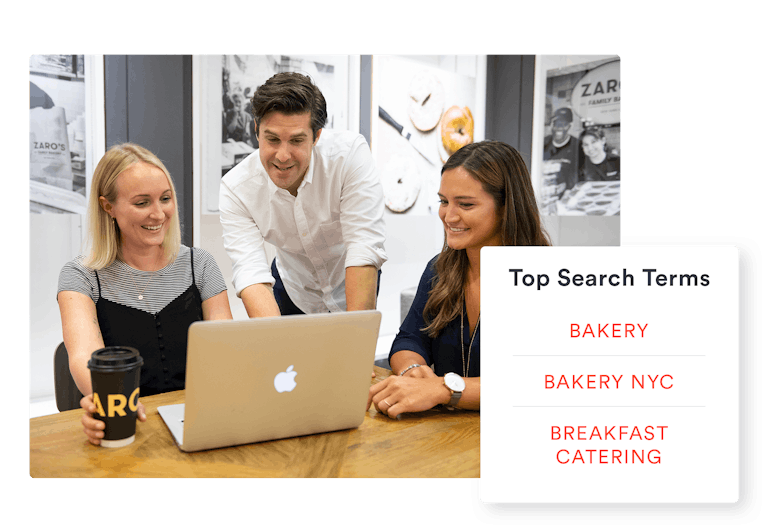 BentoBox employees showing a customer their website results
