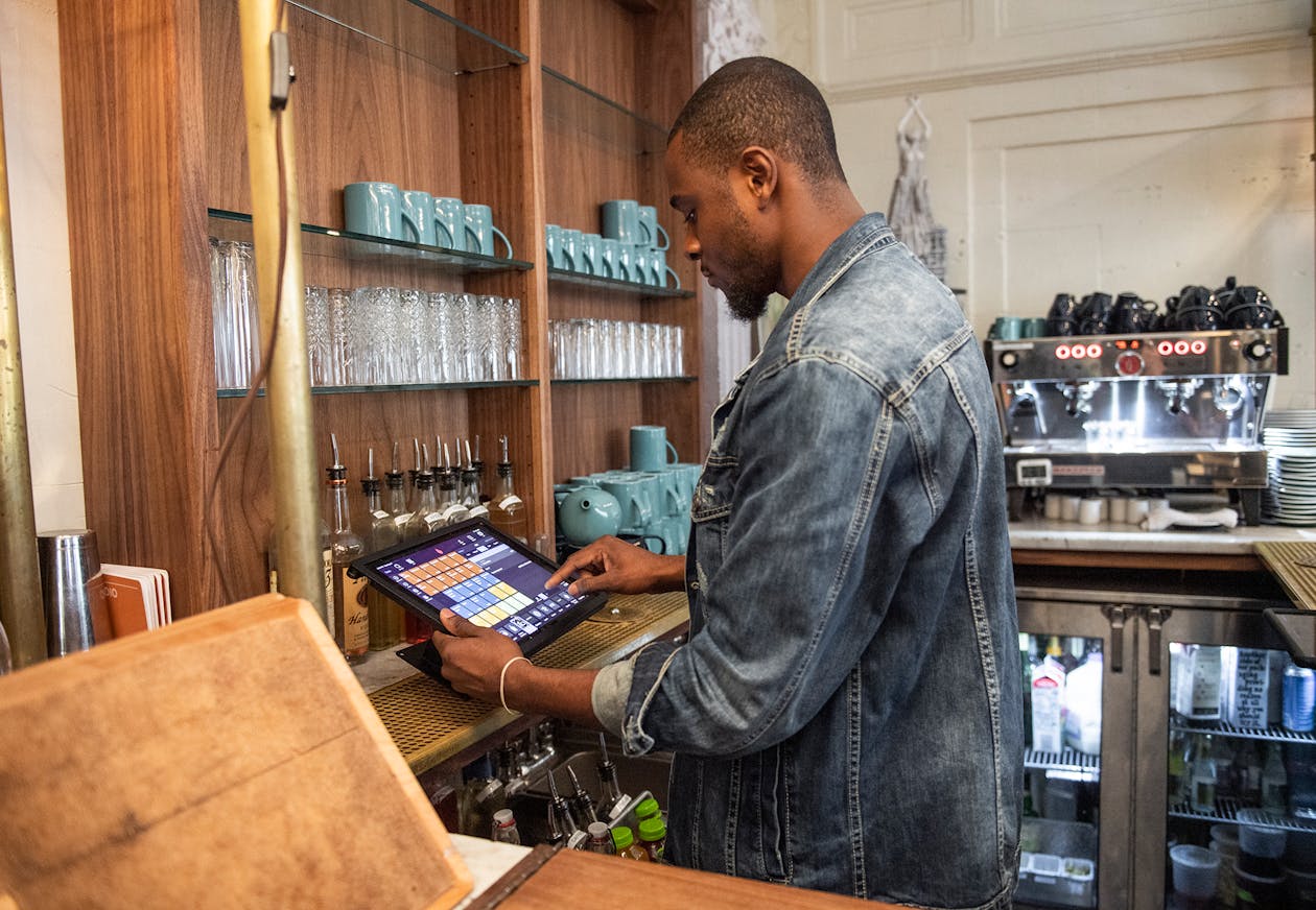 a photo of a main putting in an online order into a pos system