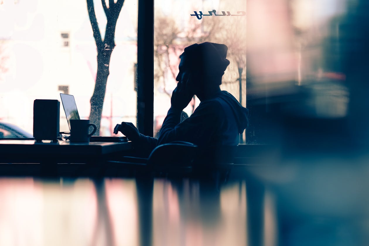 A person sitting at a cafe on their laptop looking at a restaurant website.