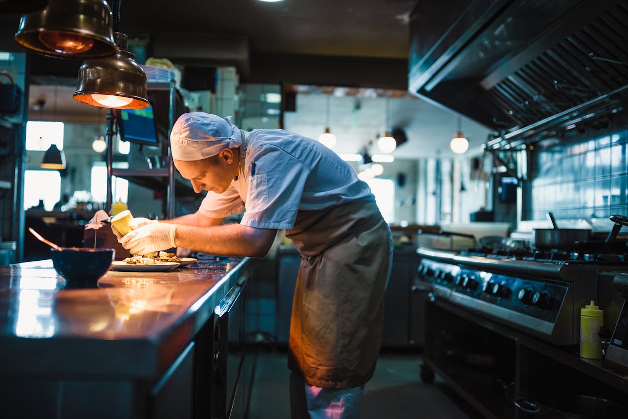 a man cooking in a kitchen preparing food