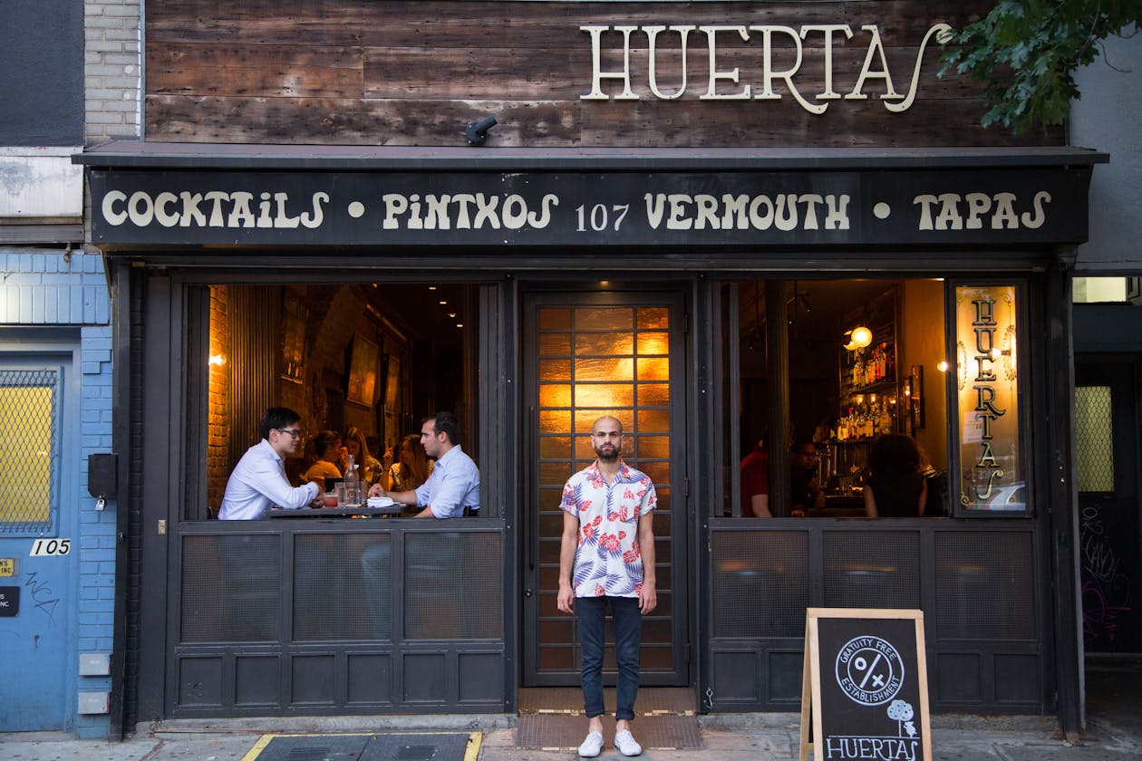 a person standing in front of a restaurant