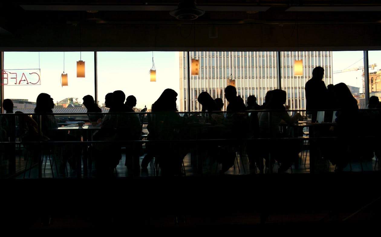 a group of people standing in front of a window