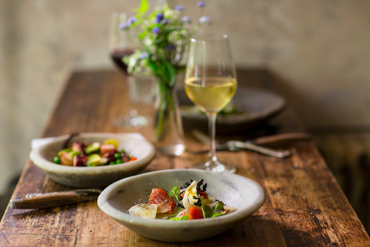 a close up of a plate of food on a wooden table