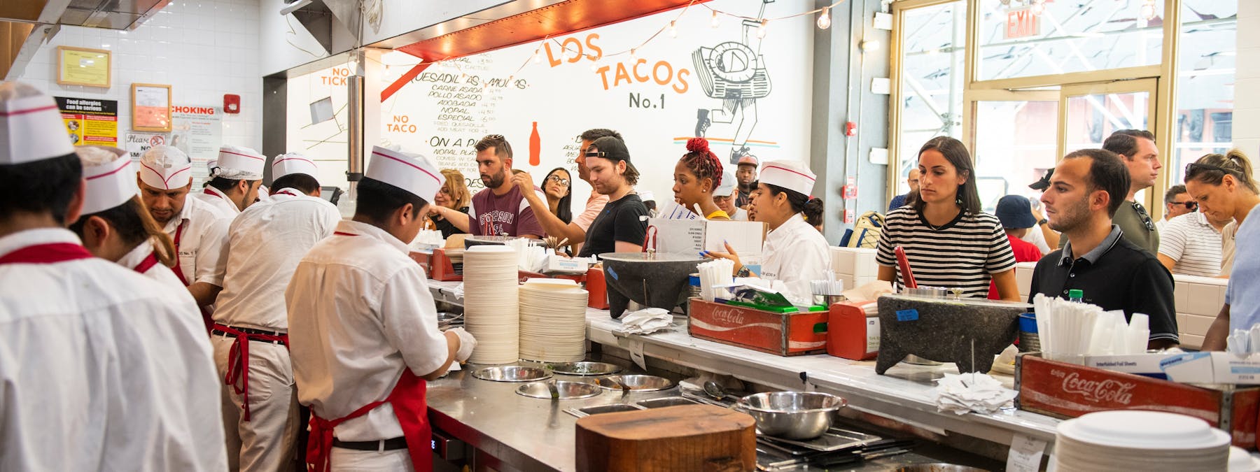 a group of people preparing food in a kitchen