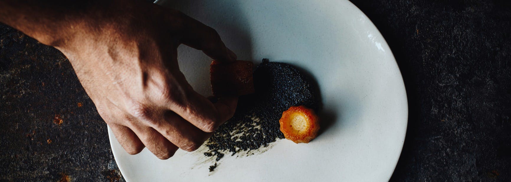 a hand plating food