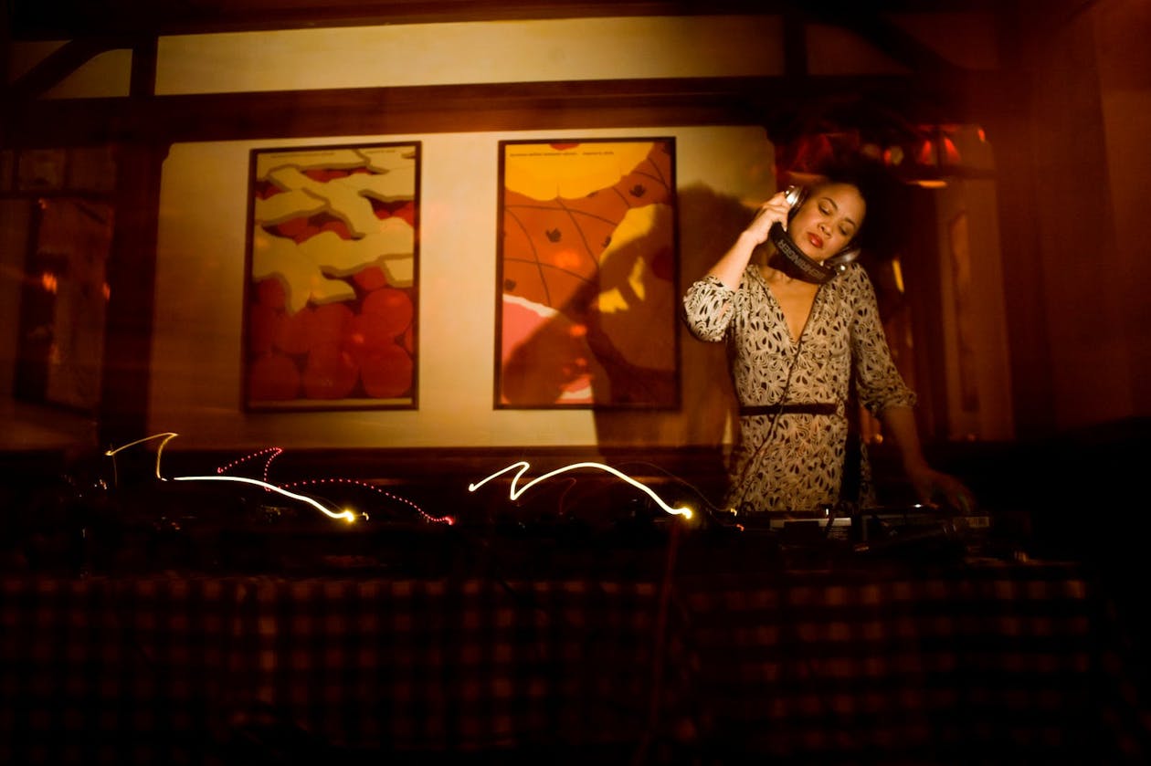 A DJ spinning music in a dark room.