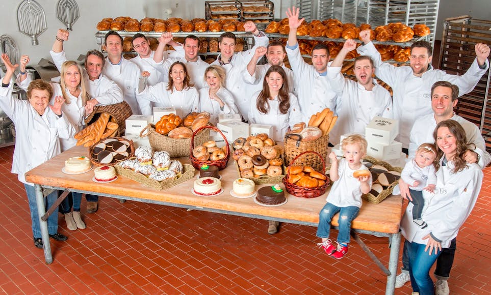 a group of people sitting at a table posing for the camera