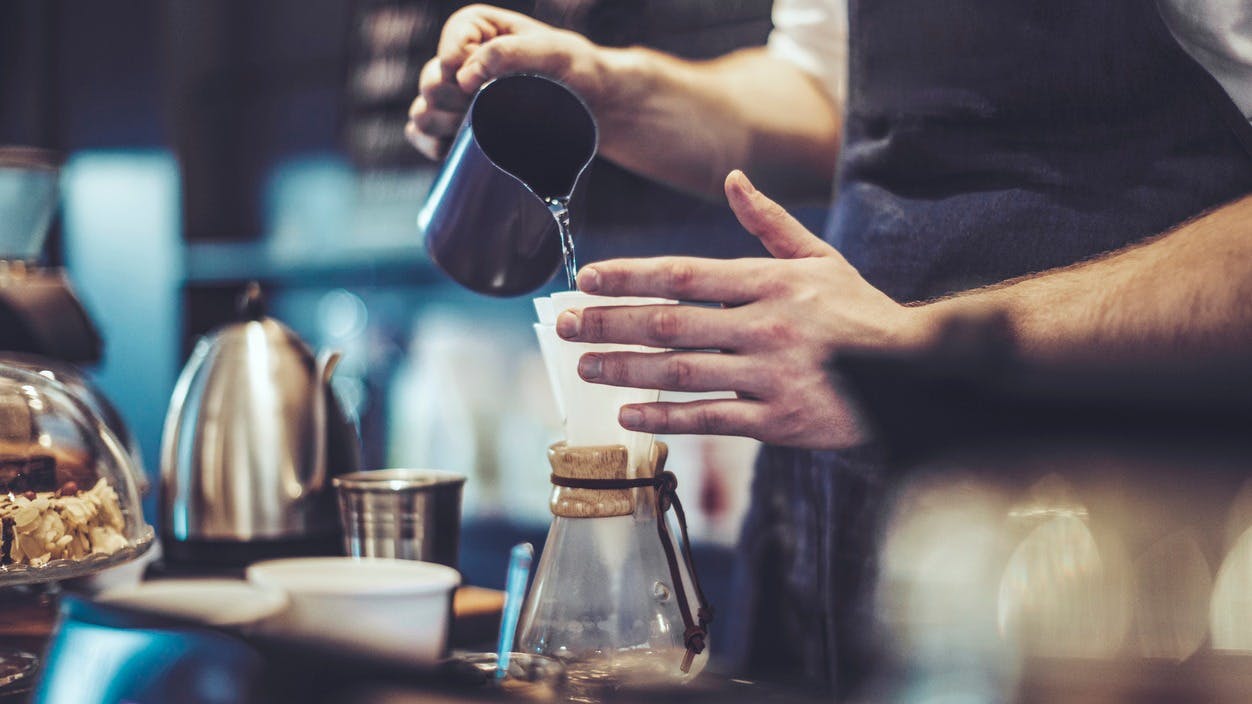 a person pouring coffee