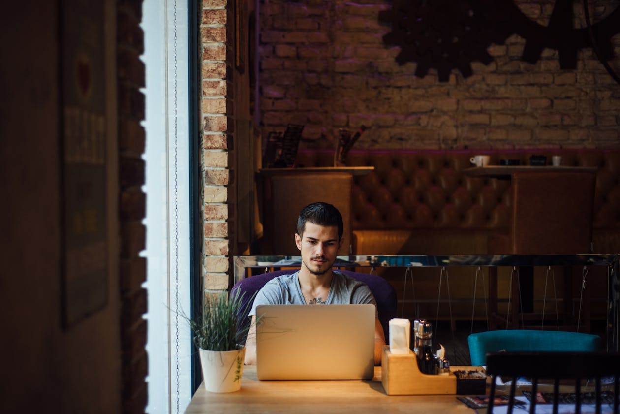 a person sitting at a table in front of a building