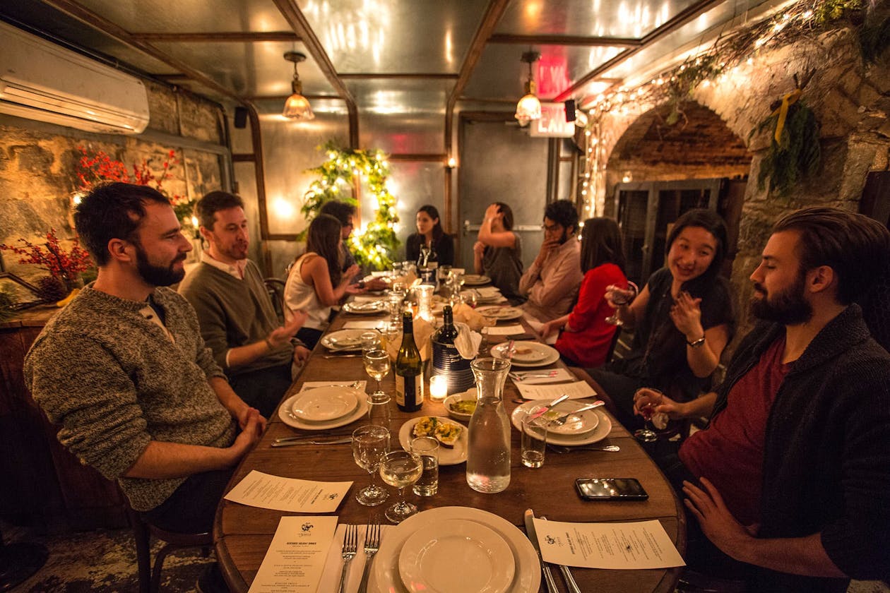 a group of people sitting at a table with wine glasses