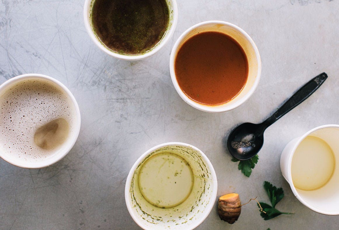 cups of broth on a table