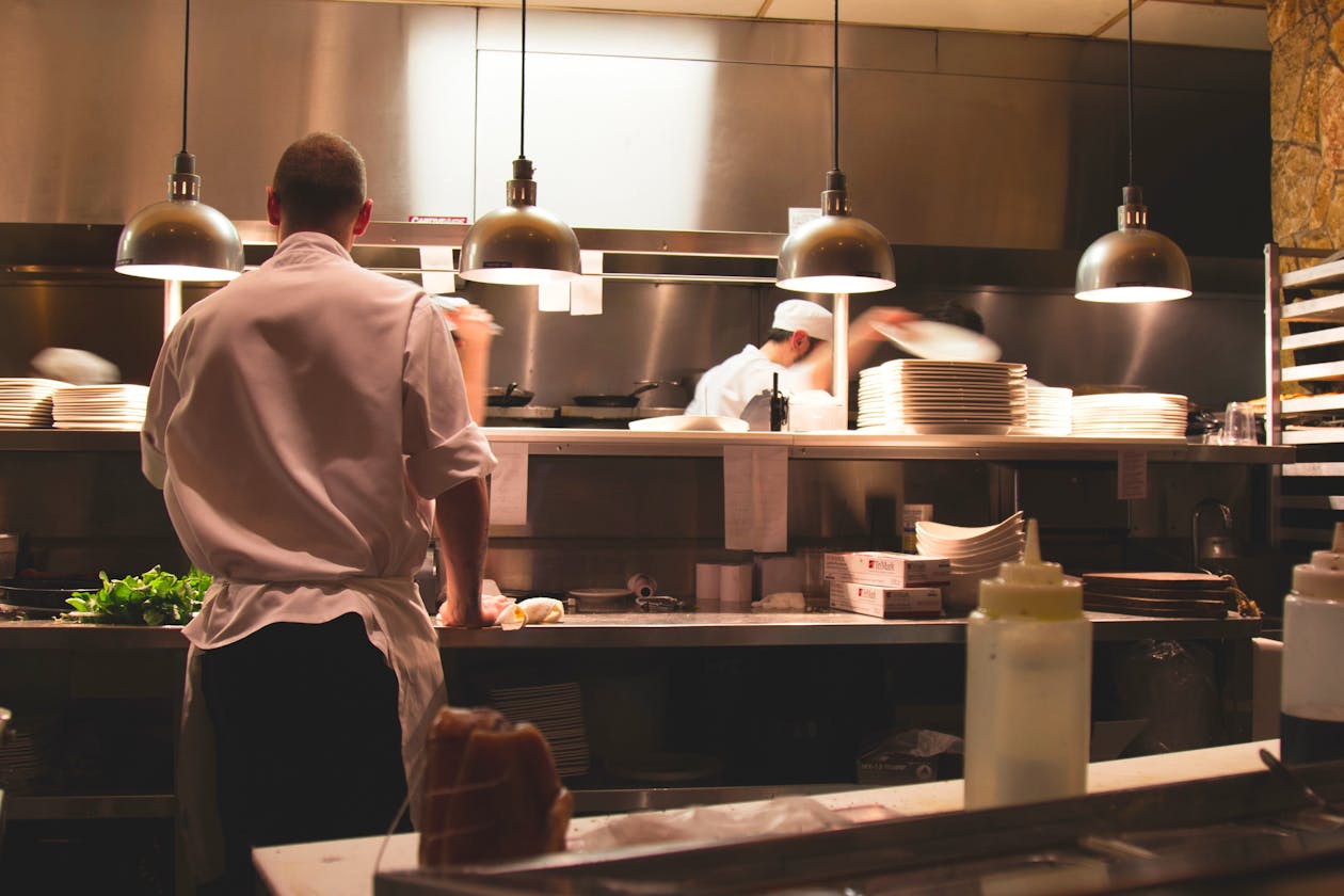 a person cooking in a kitchen preparing food